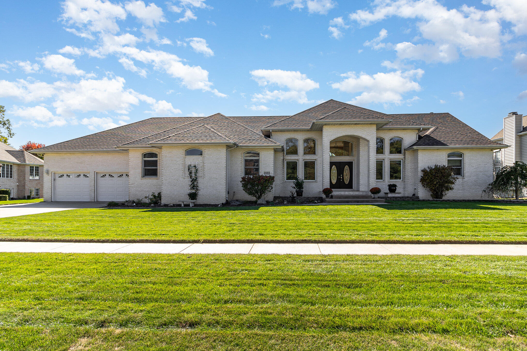 a front view of a house with a garden