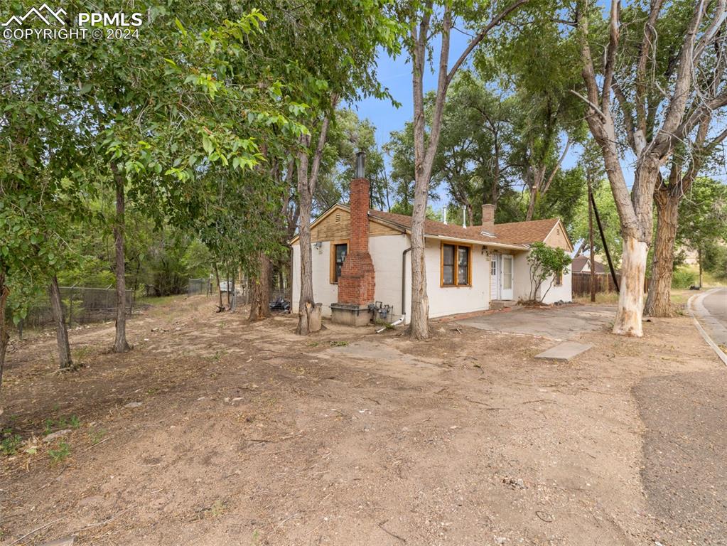 a view of a yard with a house and tree