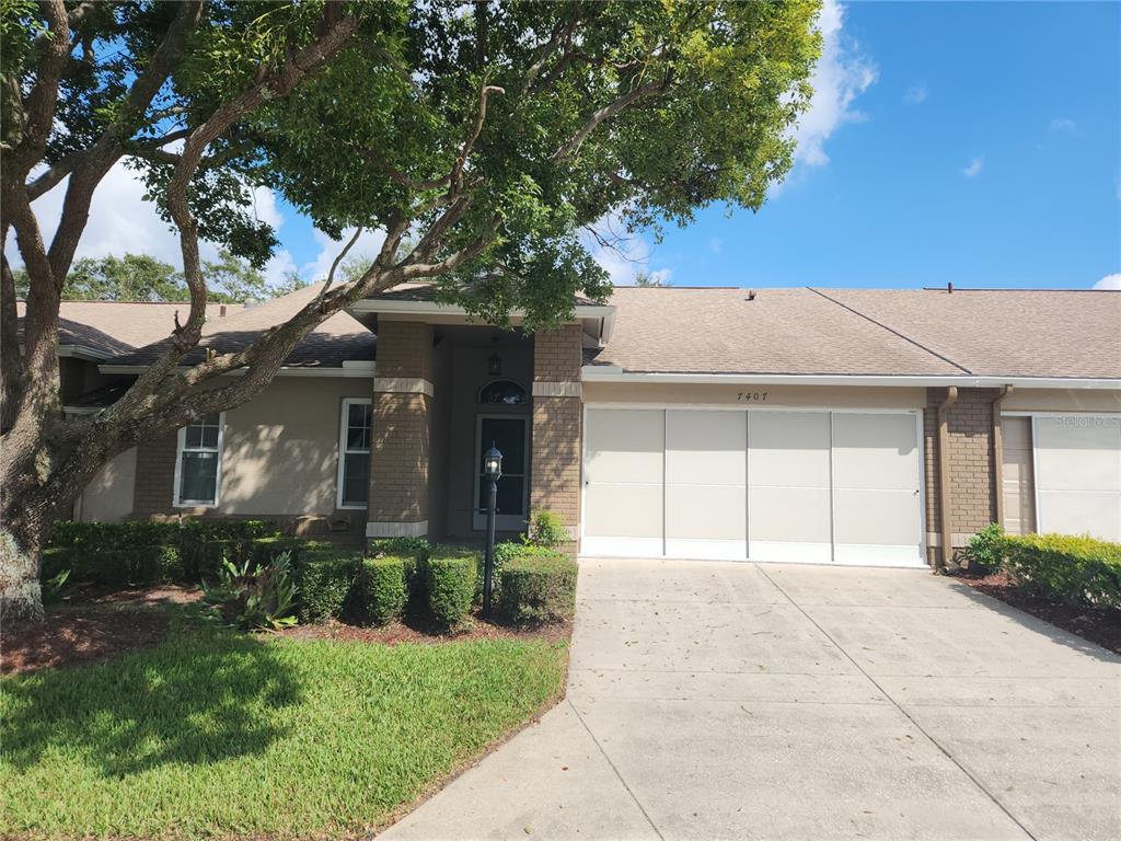 a front view of a house with a yard and garage