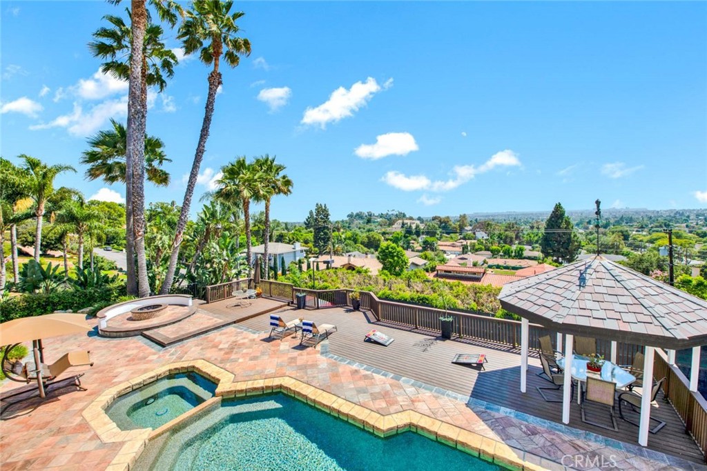 a view of a patio with swimming pool and chairs