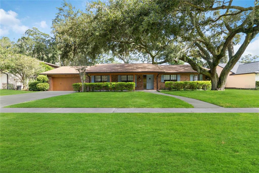 a view of house that has a yard