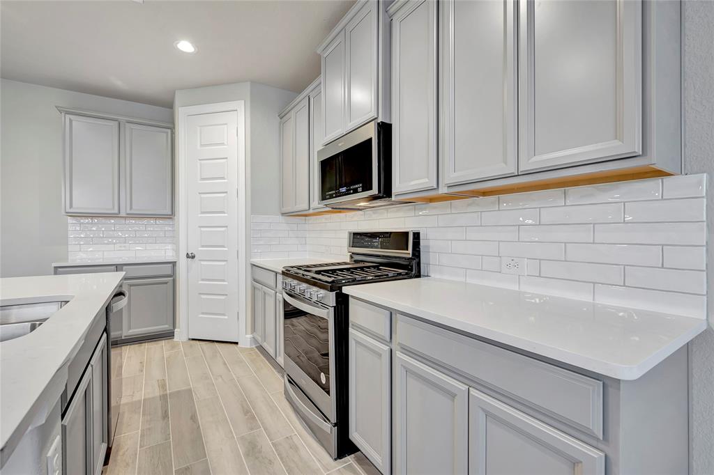 a kitchen with a sink stove and microwave