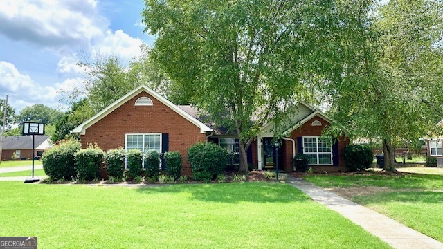 a front view of a house with a yard and trees