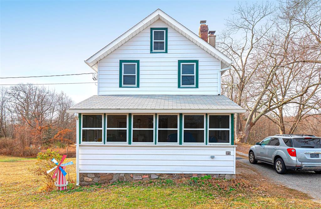 View of front of property with a sunroom