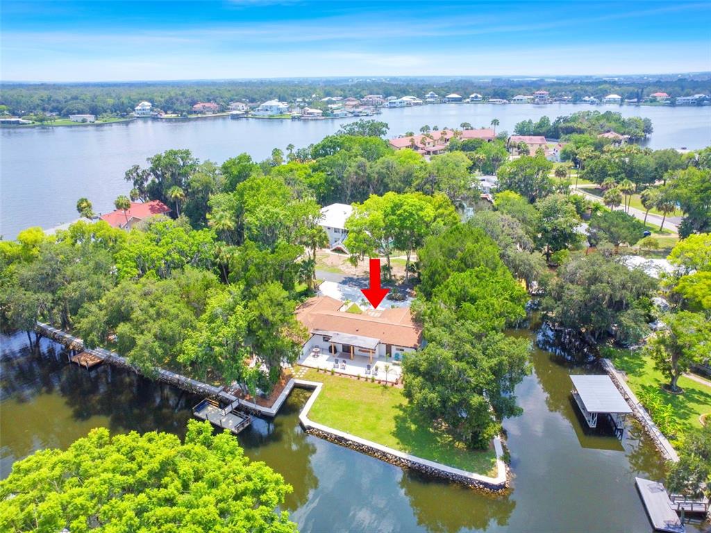 an aerial view of lake residential houses with outdoor space and swimming pool