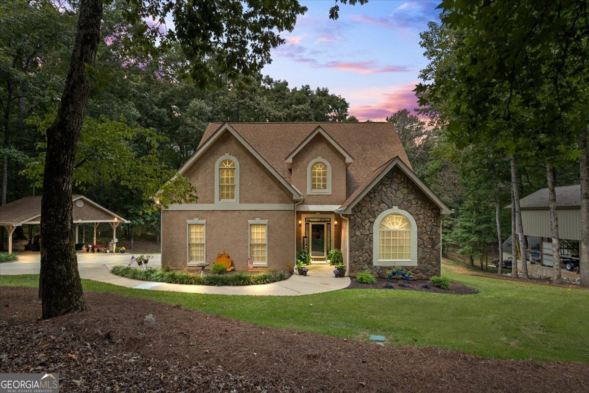 a front view of a house with a garden