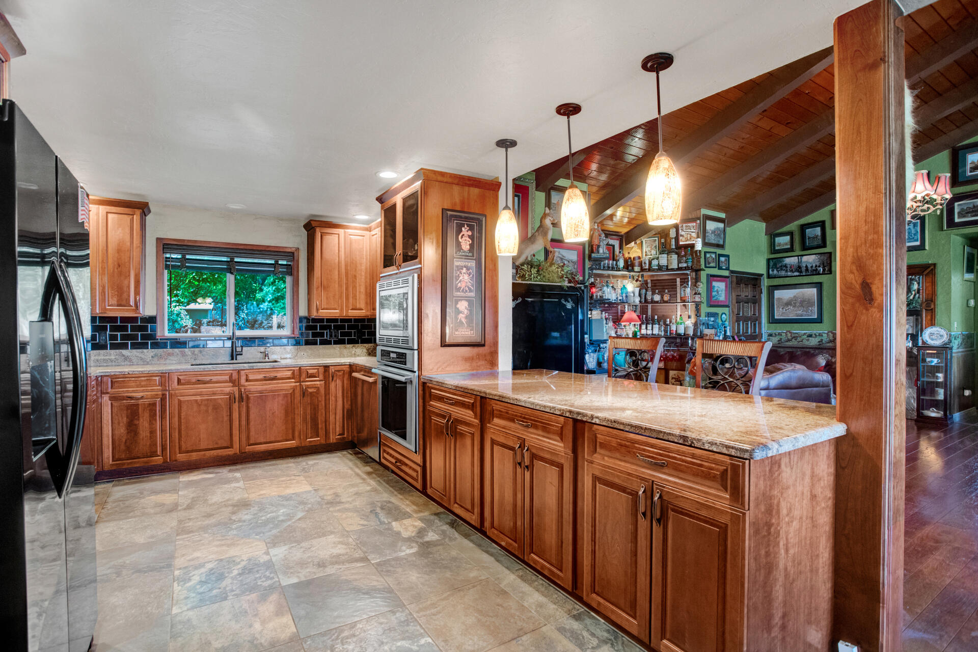 a kitchen with stainless steel appliances a sink and a large window