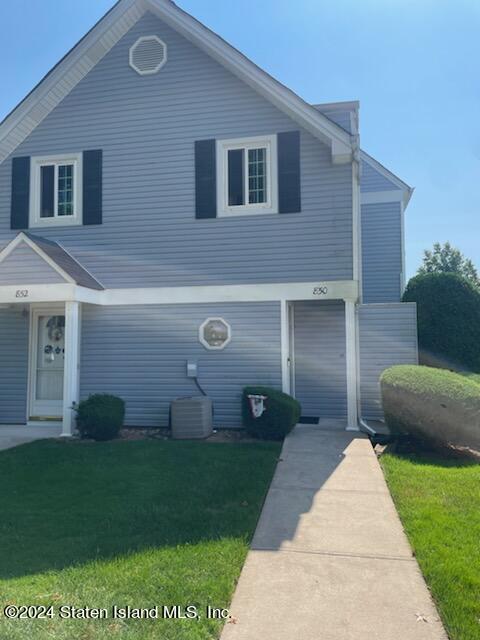 a front view of a house with a yard and a garden