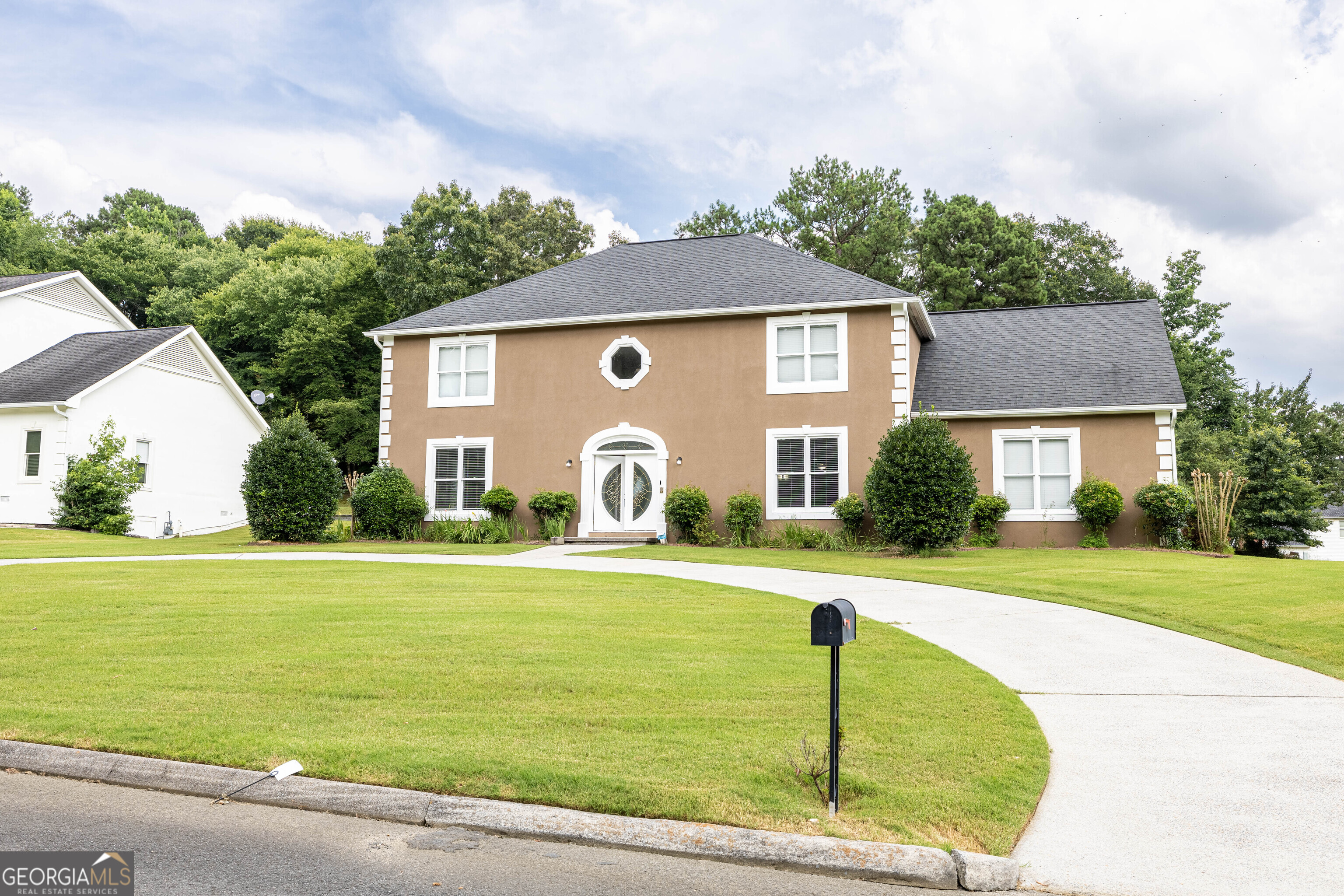 a front view of a house with garden