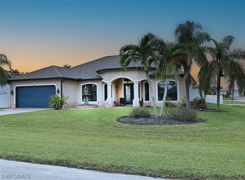 a front view of a house with a garden