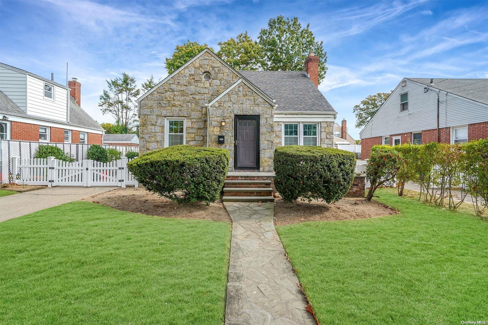 a front view of a house with a garden