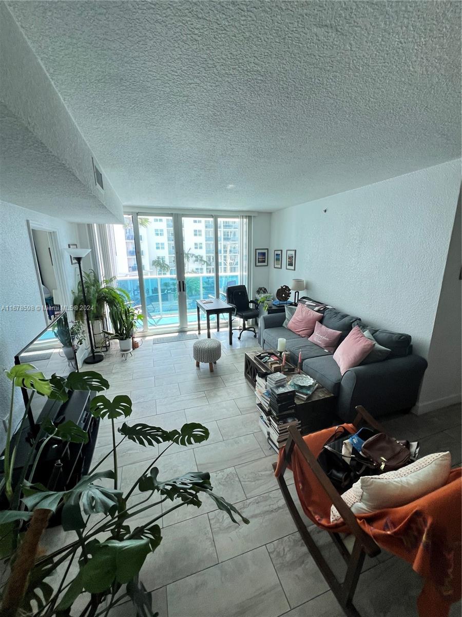 a living room with furniture and a potted plant