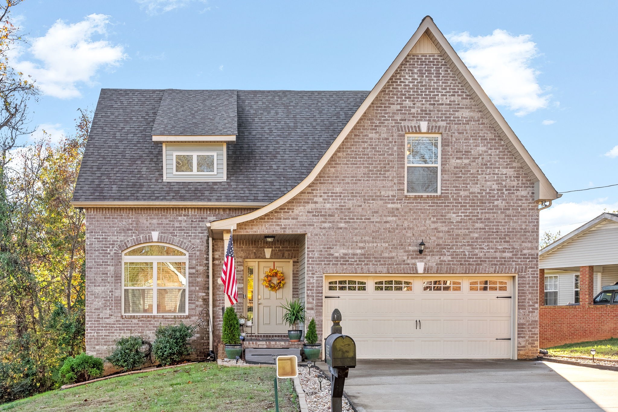 a view of a brick house next to a yard