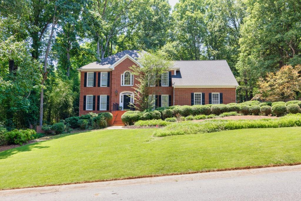 a front view of a house with a yard