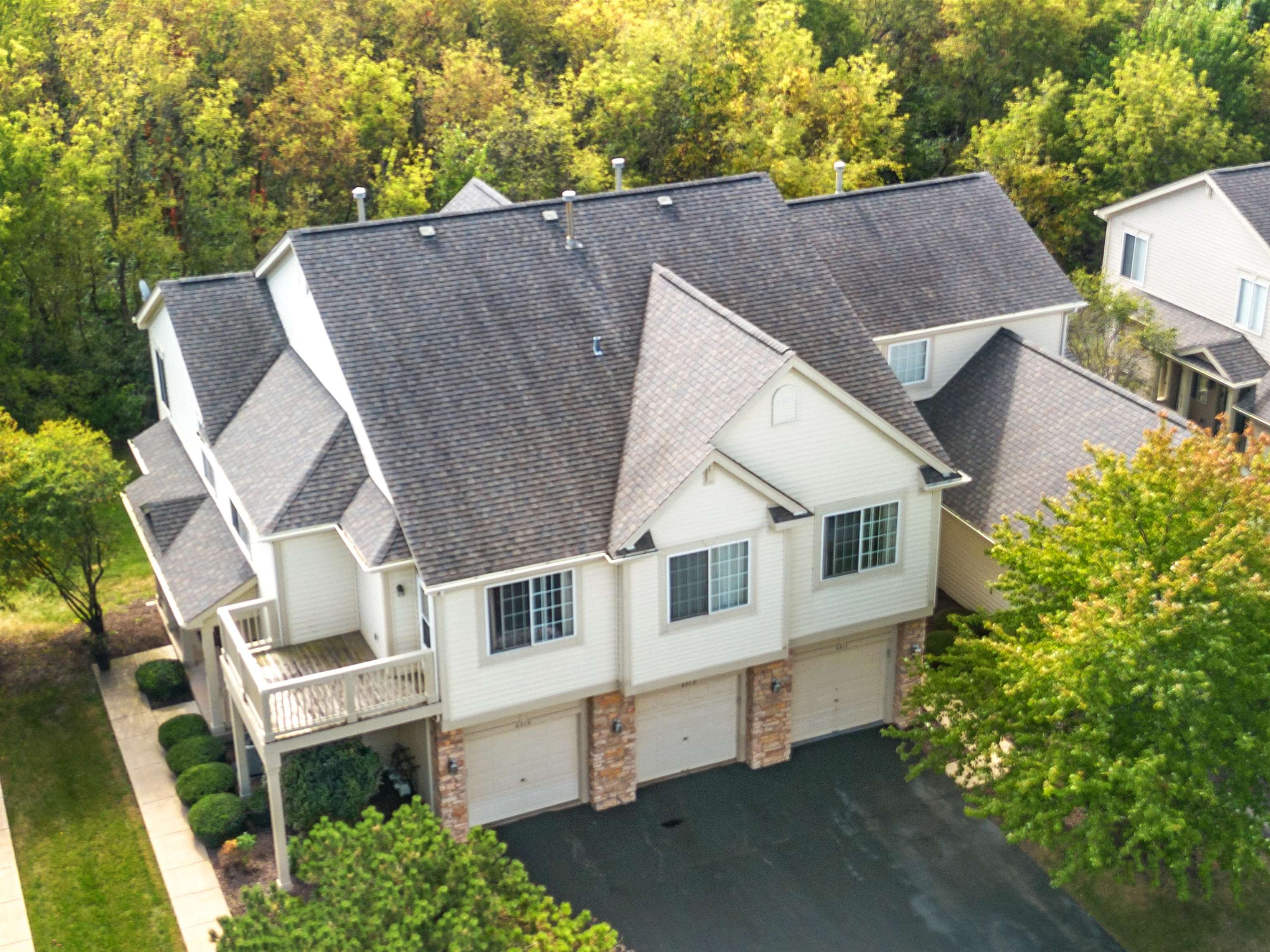 a aerial view of a house with a yard and large tree