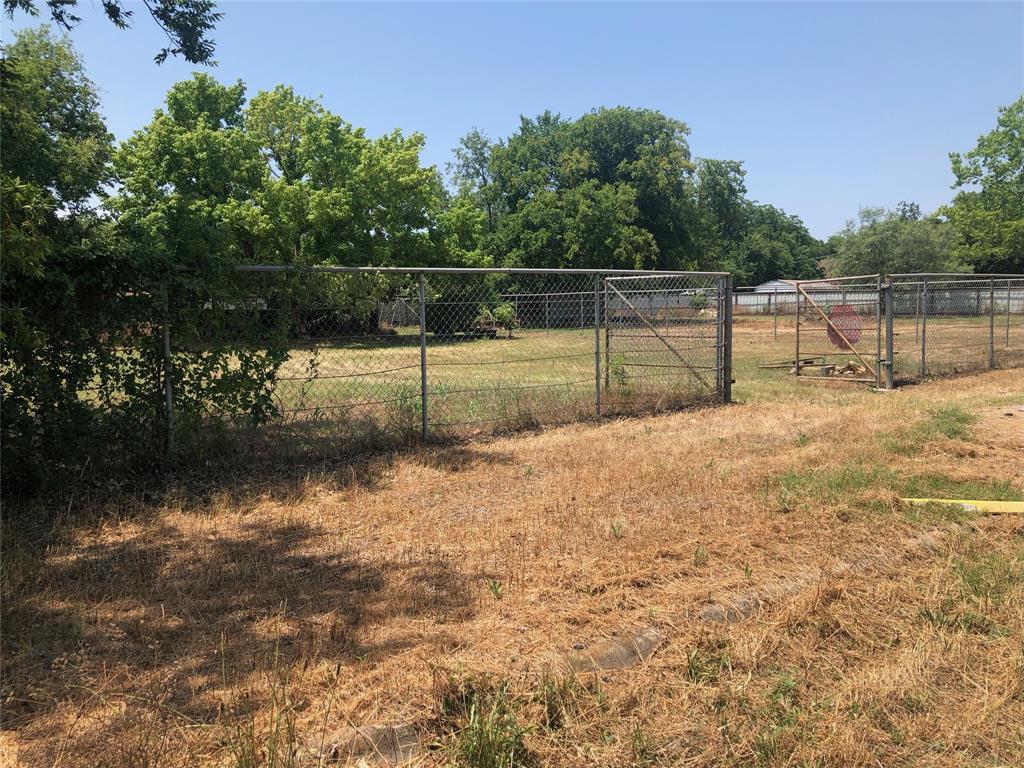 a view of yard with wooden fence