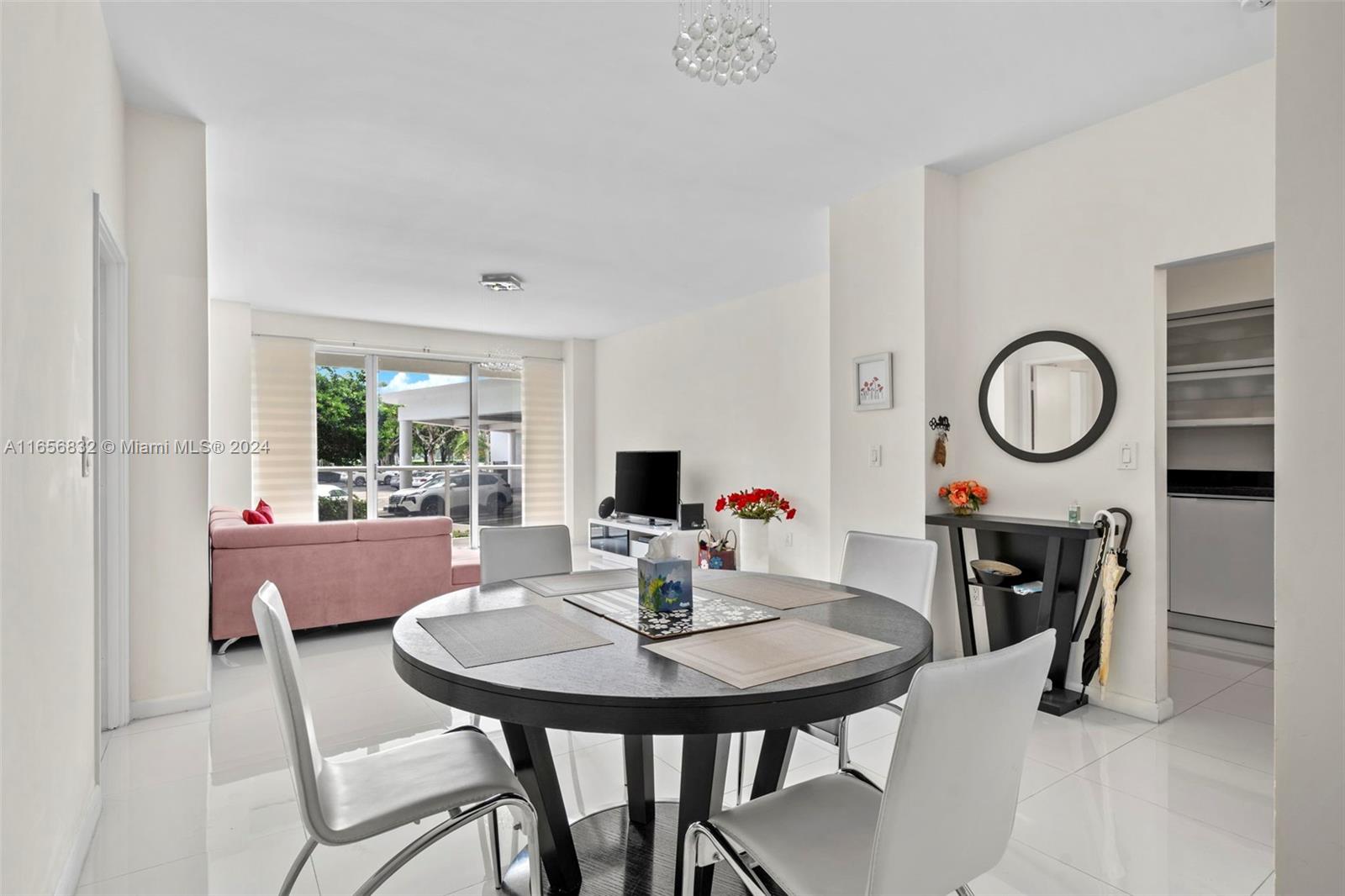 a view of a dining room with a table and chairs