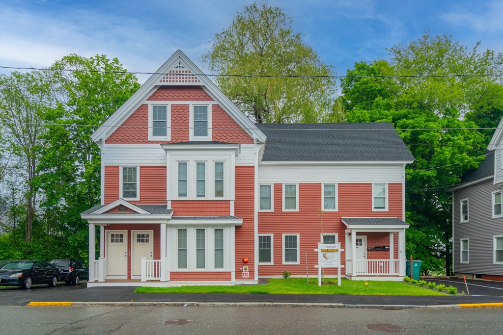 front view of brick house with a yard