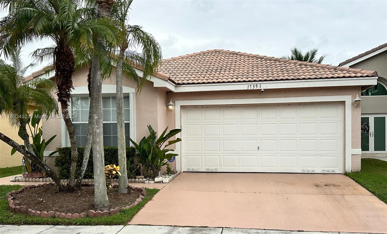 a view of a house with a yard and garage