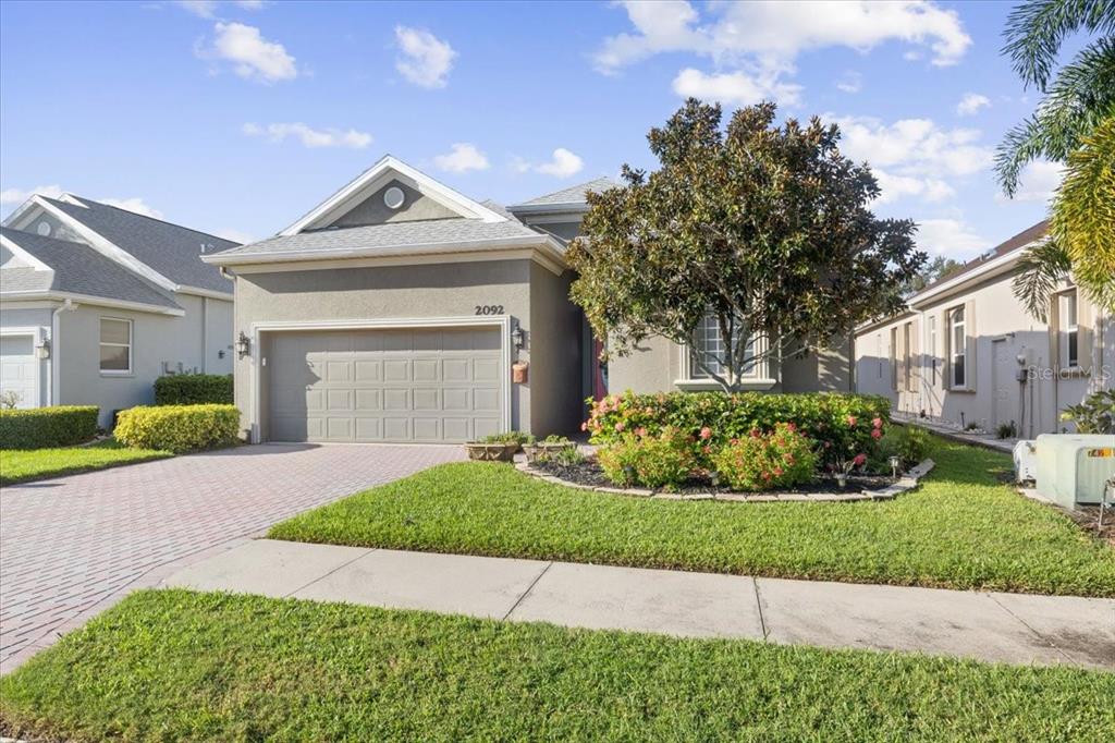 a front view of a house with a yard and garage