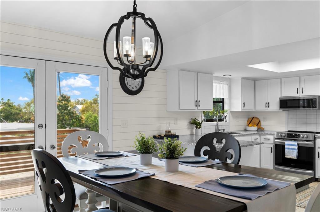 a kitchen with a sink a stove and a dining table with kitchen view