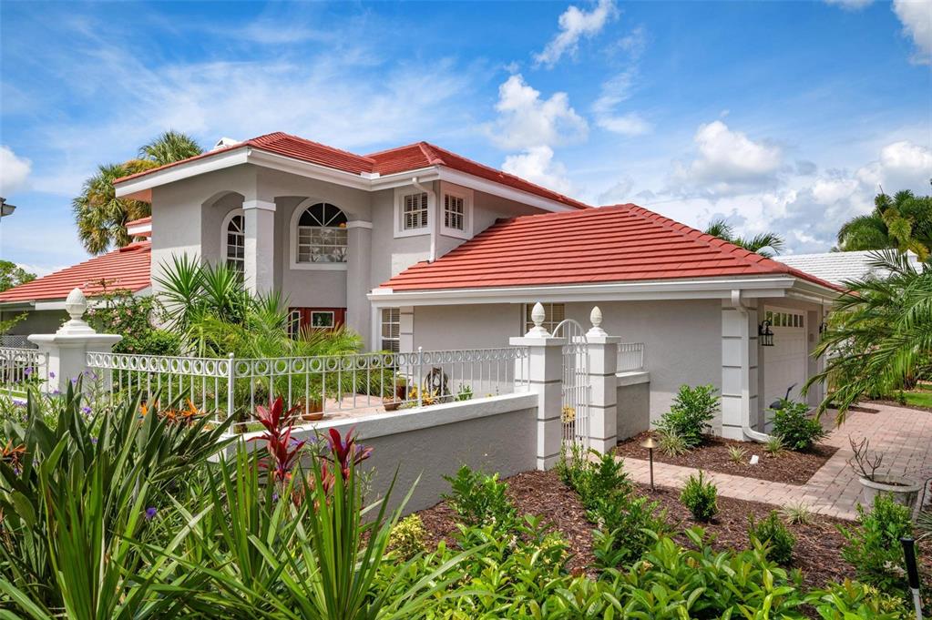 a front view of a house with a garden