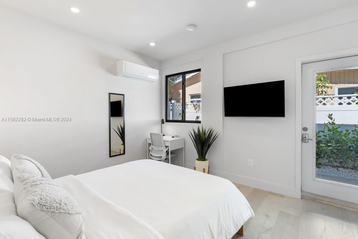 a bedroom with a bed and a flat screen tv