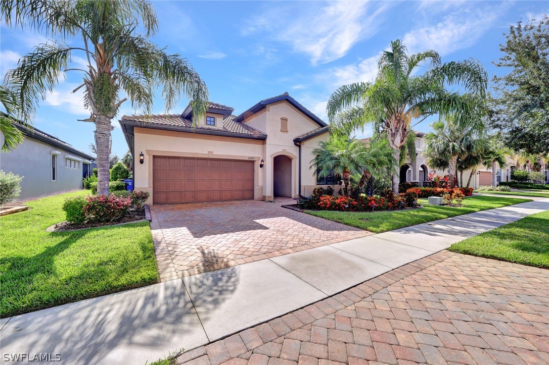 a front view of a house with a yard and a garage