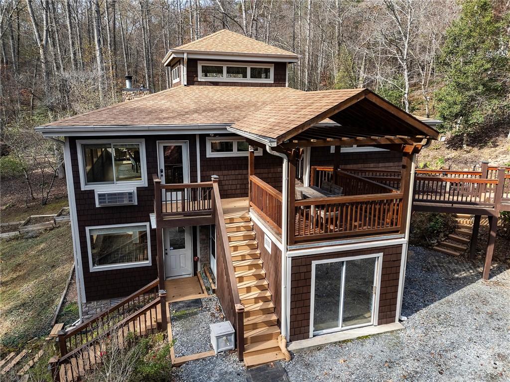 a front view of a house with a yard and balcony