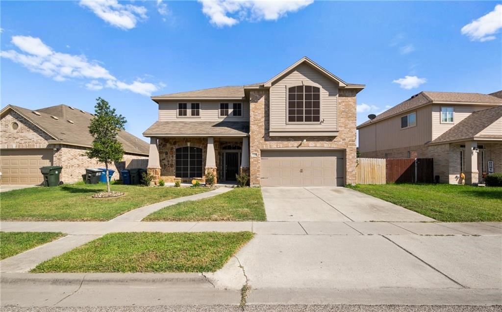 a front view of a house with a yard and garage