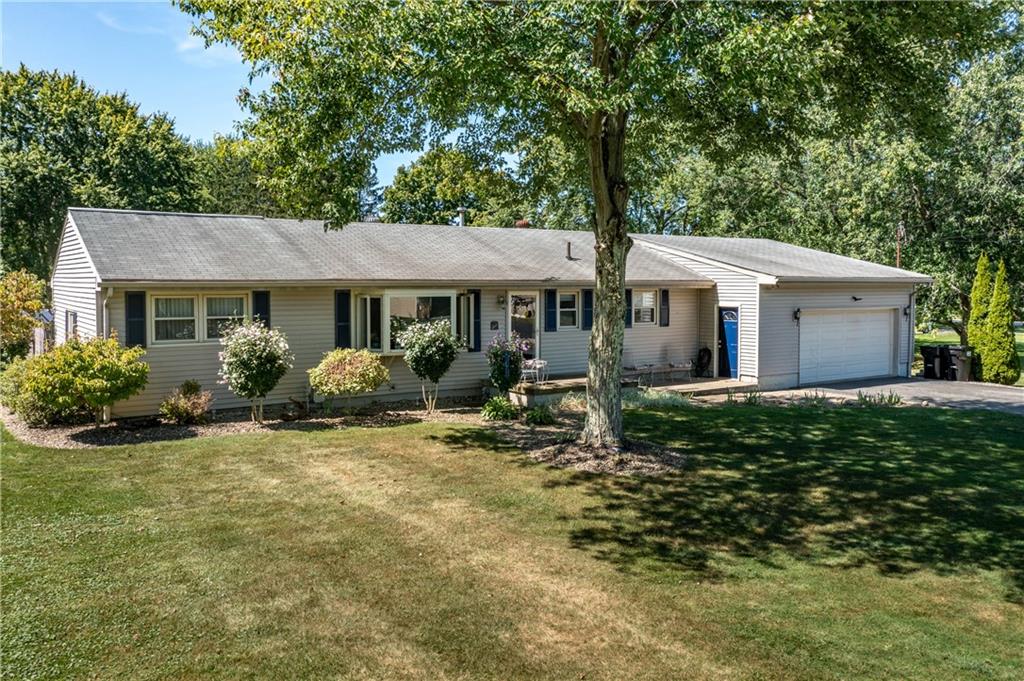 a view of a house with a yard siting area and garden