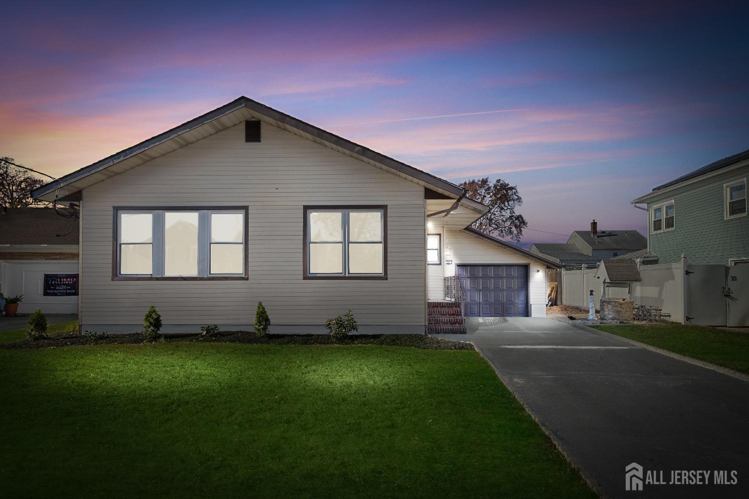 a front view of a house with a garden