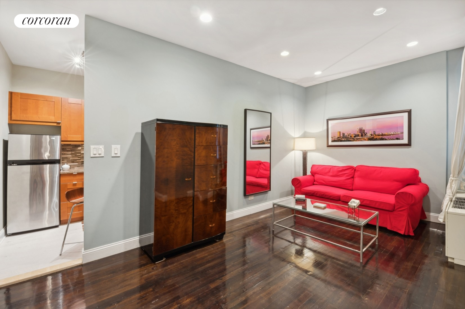 a living room with furniture and wooden floor