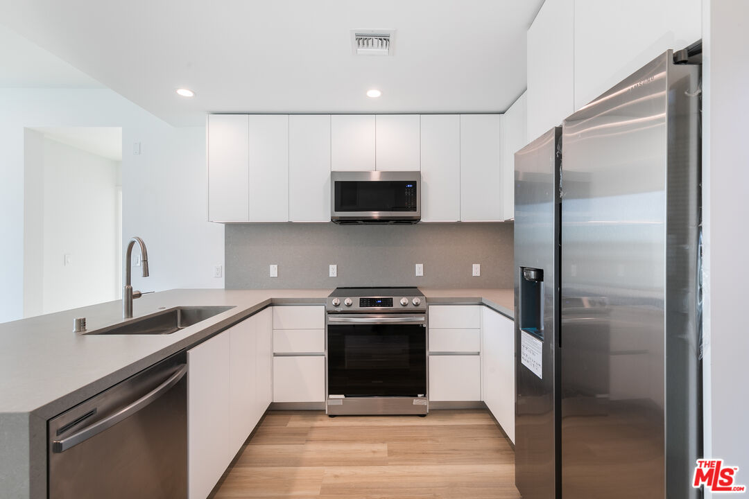 a kitchen with a sink and a refrigerator