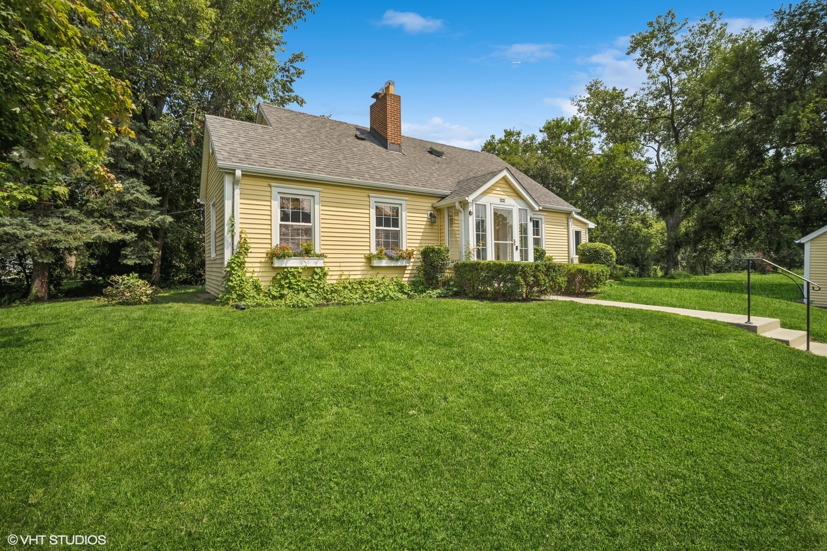 a front view of house with yard and green space