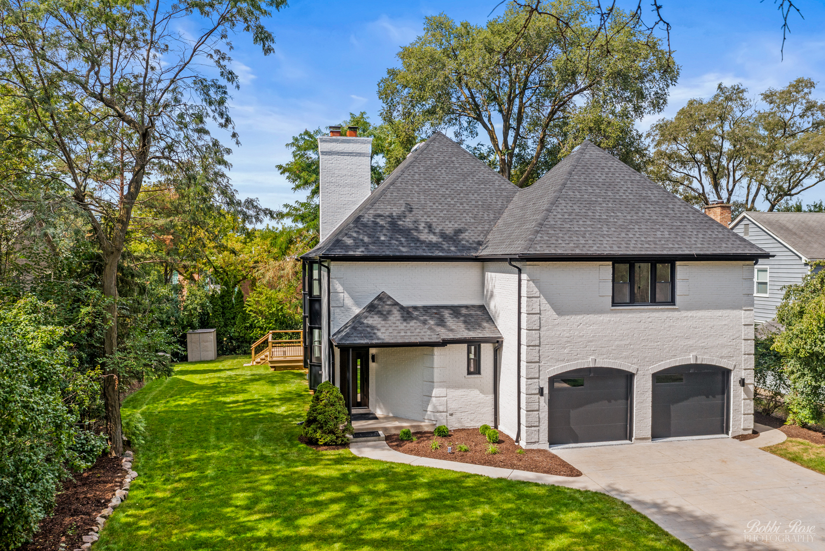 a front view of a house with a garden and yard