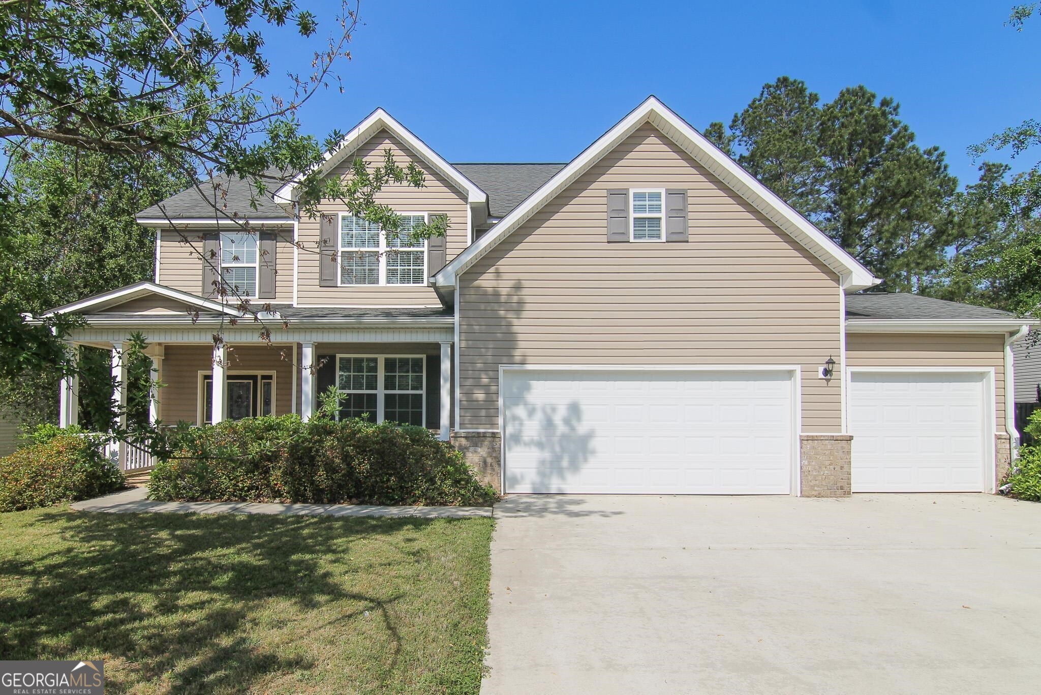 a front view of a house with a yard and garage