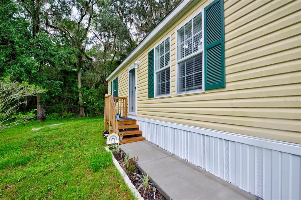 a view of backyard with deck and garden