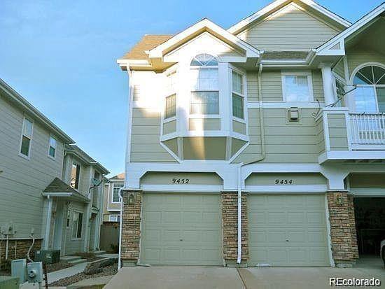 a view of a house with a garage and balcony