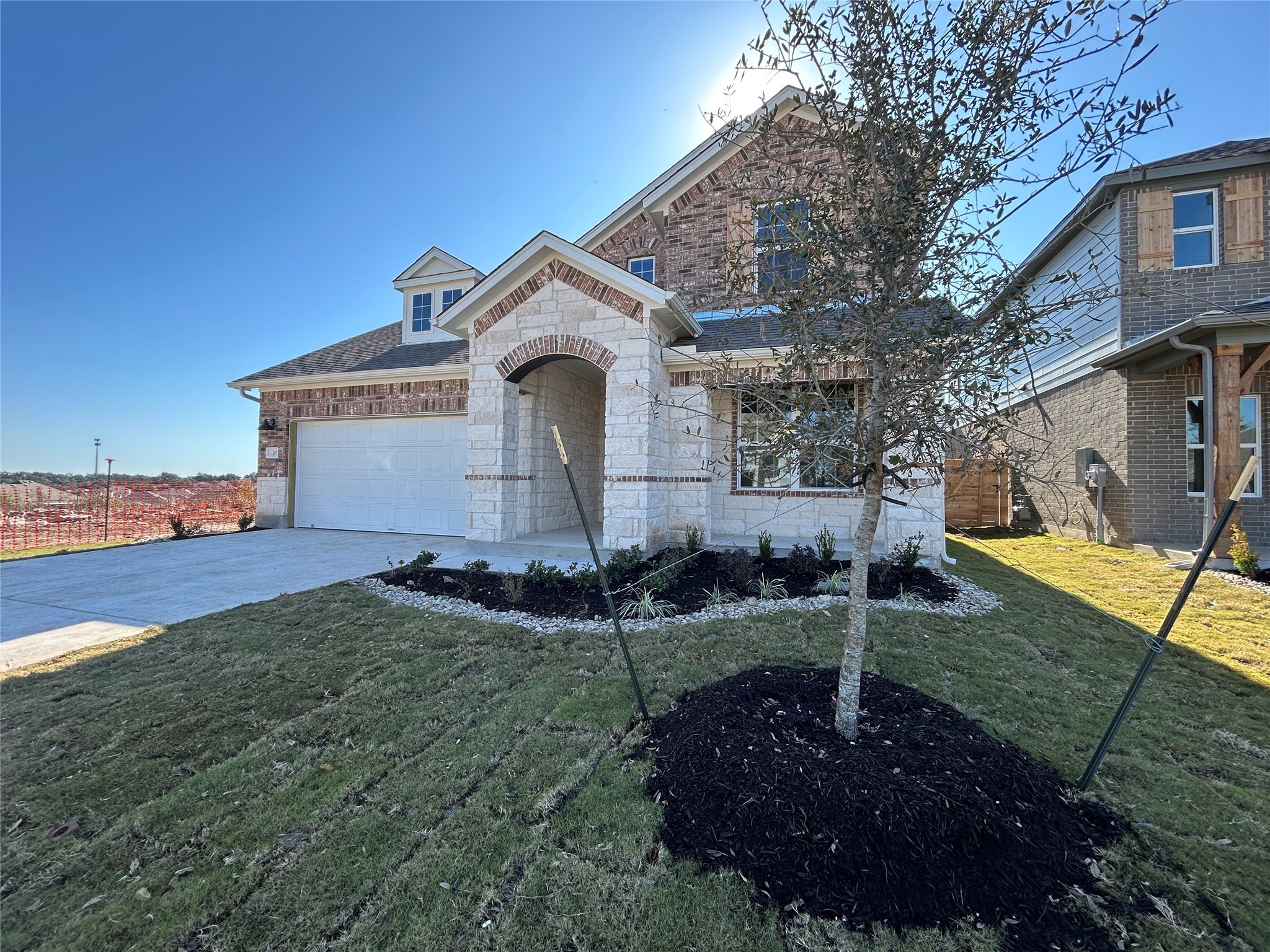 a front view of a house with garden