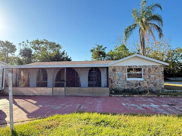 a front view of house with yard and trees in the background