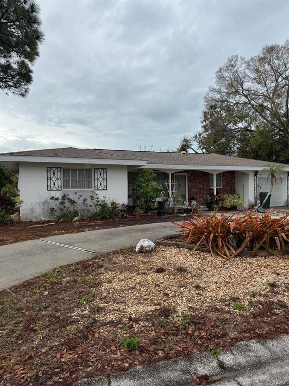 a front view of a house with a yard and potted plants