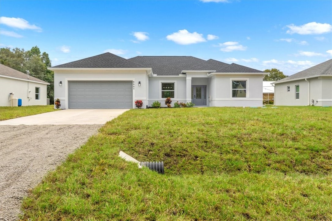 a front view of a house with a yard and garage