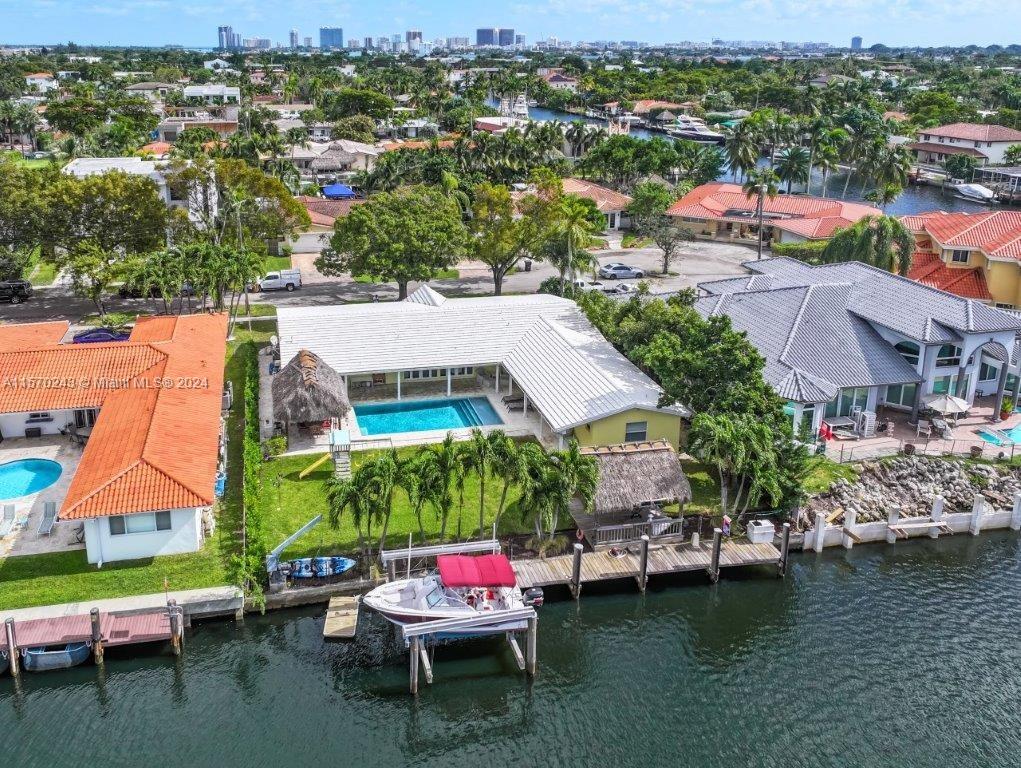 an aerial view of a house with a garden and lake view