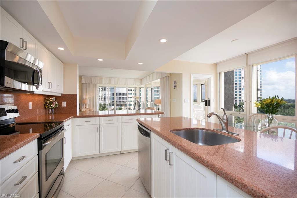 a kitchen with granite countertop a sink and cabinets