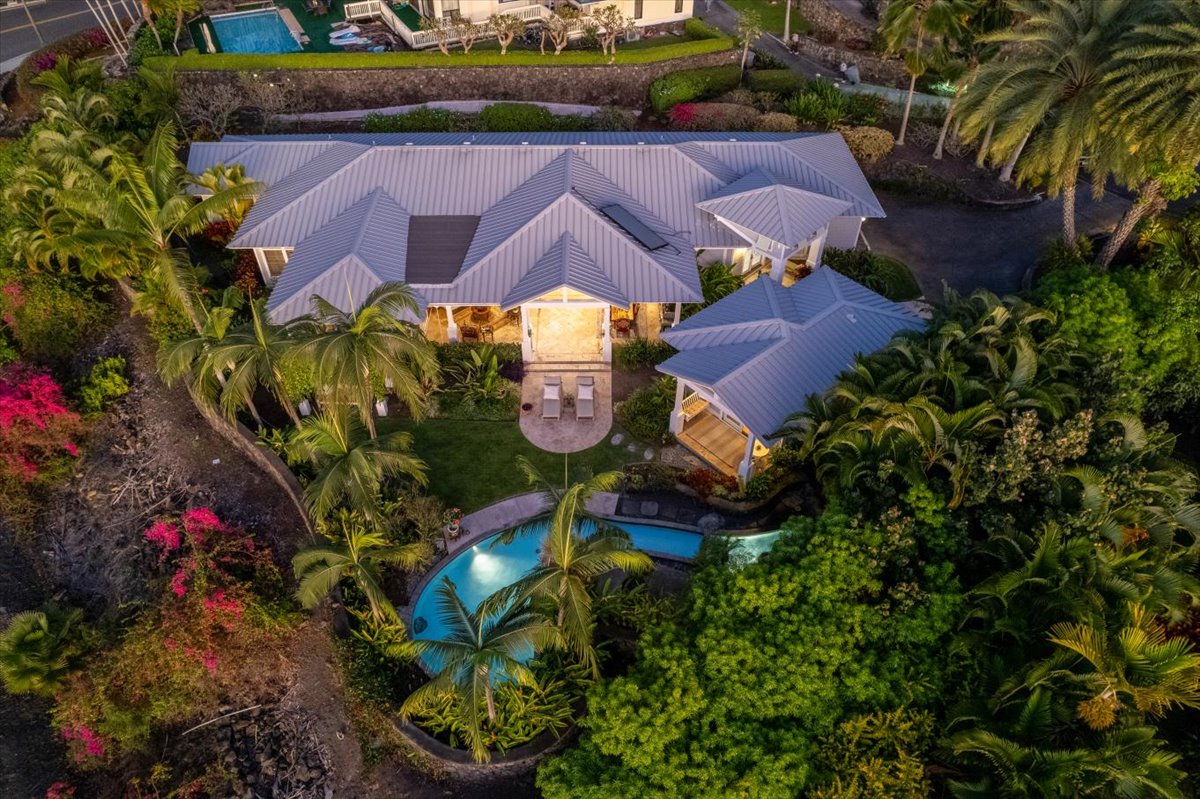 an aerial view of residential houses with outdoor space and trees