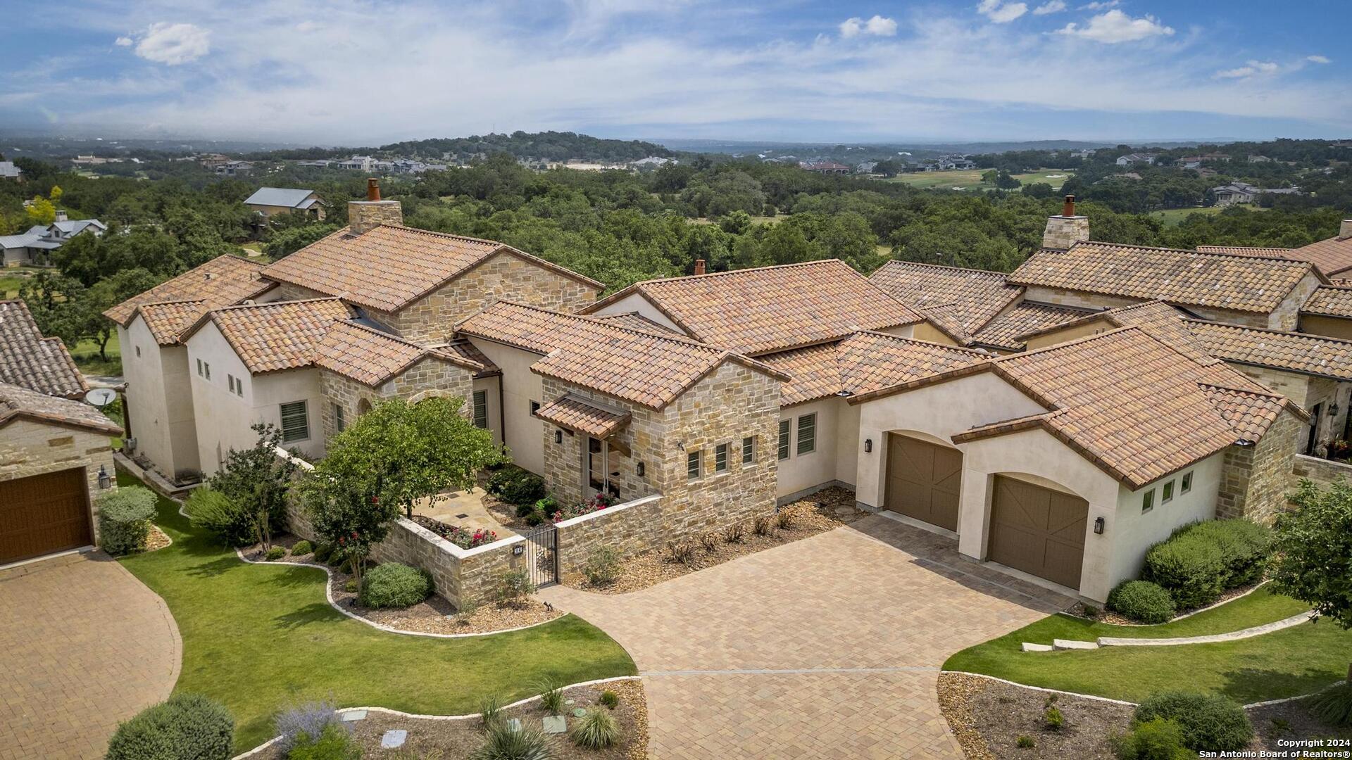 an aerial view of a house with garden space and ocean view