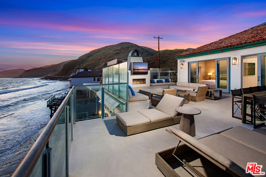 a terrace of a house with outdoor seating