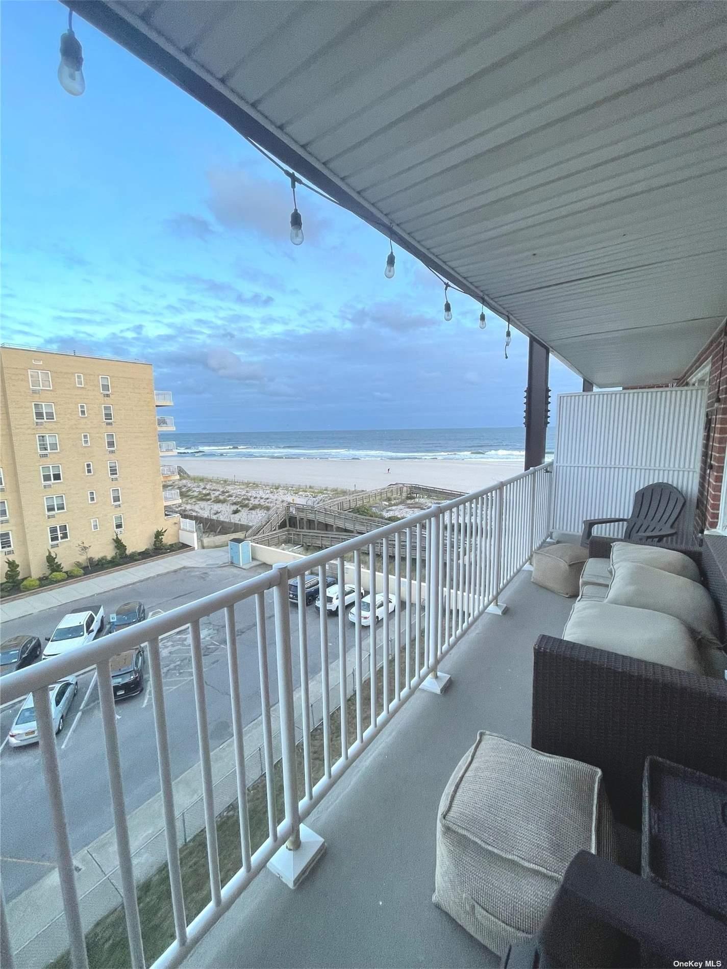 a balcony with furniture and wooden floor