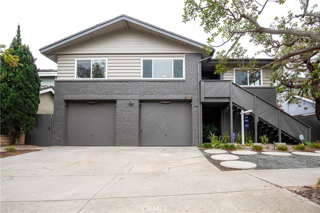 a front view of a house with garage and glass windows